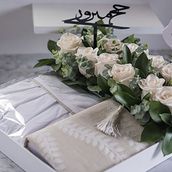 White Tray With pray dress and mus'haf decorated with natural white flower.