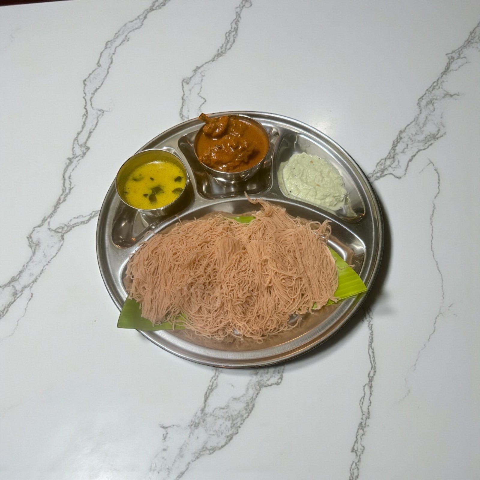 Idiyappam( String hoppers) come with chicken curry. dhal and chutney
