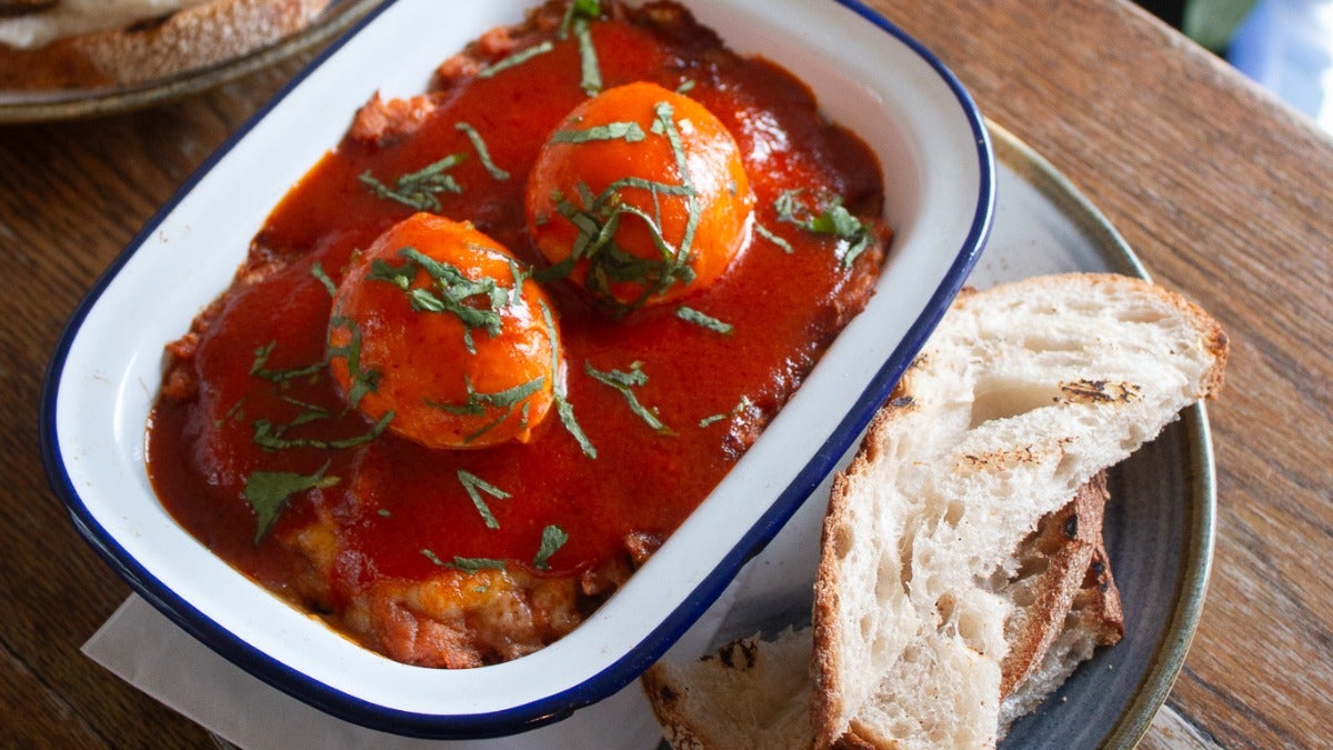 Sweet Potato Shakshuka - Two Poached Eggs, Cheddar, Sriracha Butter & Pickled Onions served with Sourdough Bread