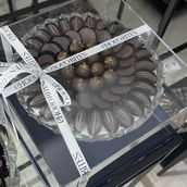Assorted medium chocolates in a transparent box