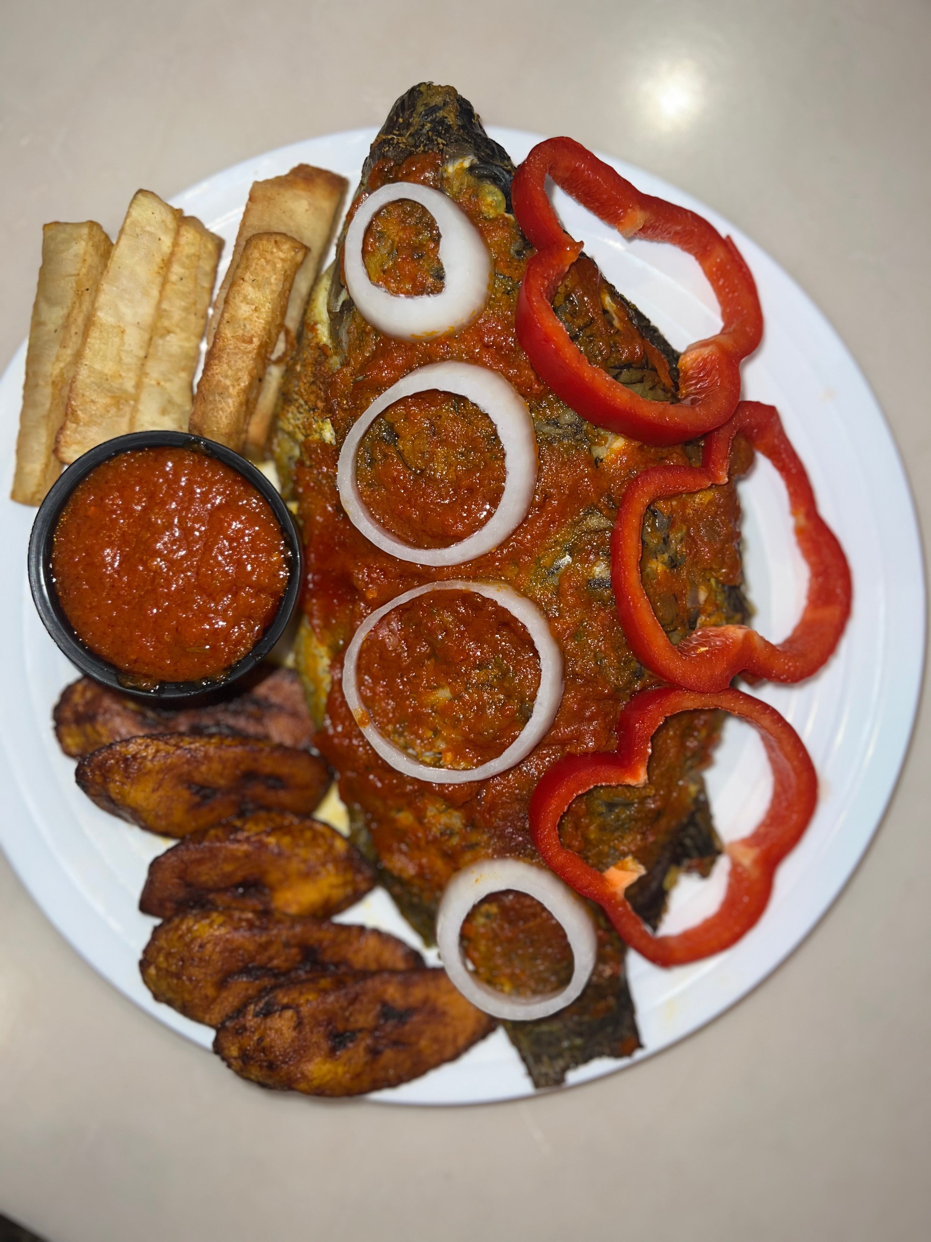 Grilled Large Tilapia Fish (Share size) served with choice of Coleslaw, Fried Yam or Fried Plantain