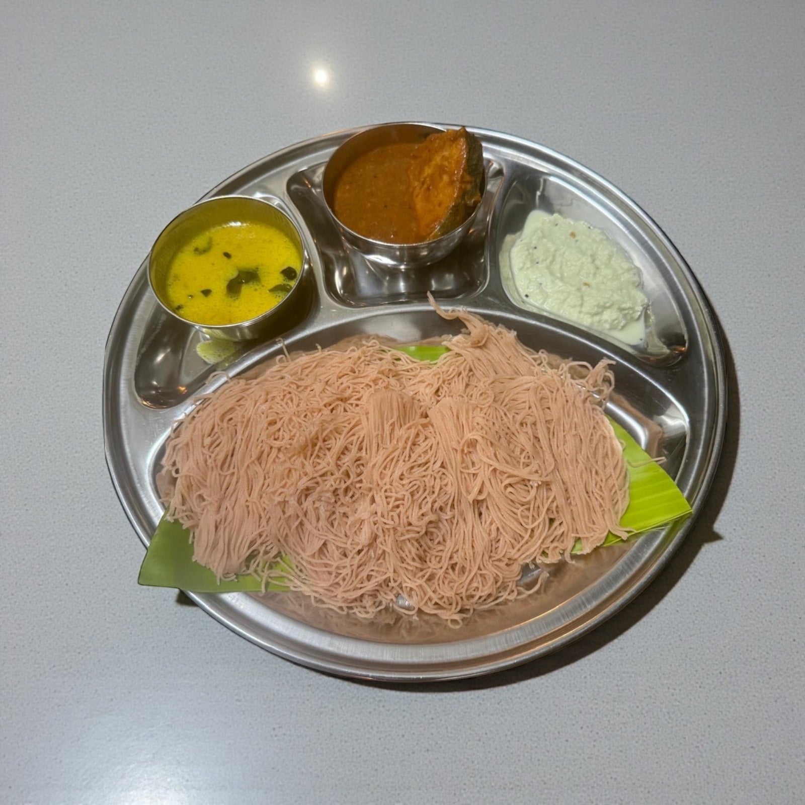 Idiyappam( String hoppers) come with fish curry. dhal and chutney