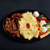Beef in BBQ sauce with mash potato and vegetables.