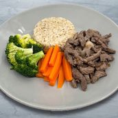 Beef Strips In Onions Brown Rice Broccoli And Carrot