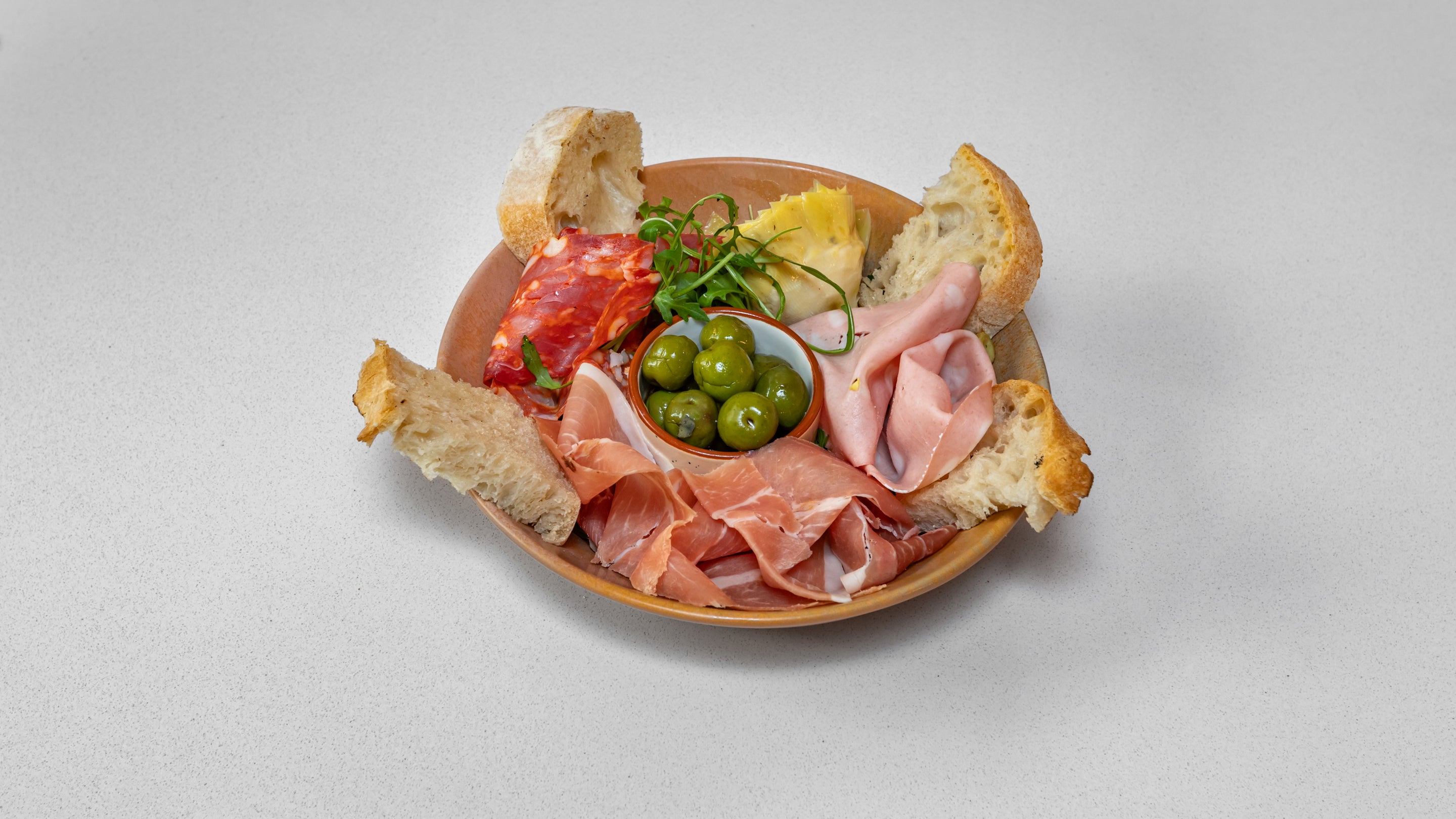 Cured Italian Meat Platter, Olives, Artichoke, and Rocket Leaves