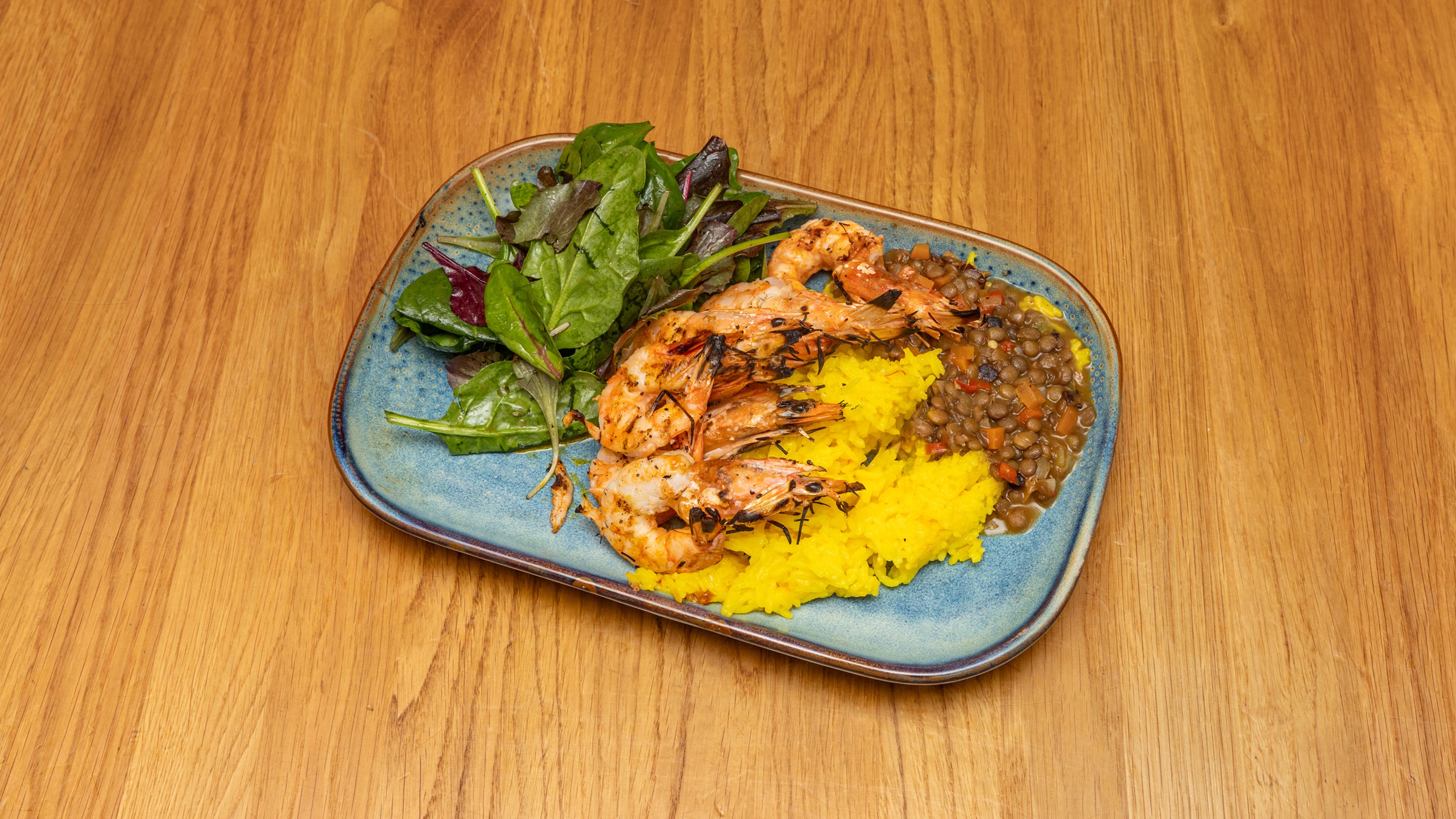Marinated grilled king prawns, with basmati rice and lentils.