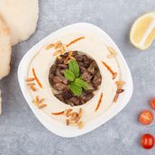 Hummus With Meat and pine nuts