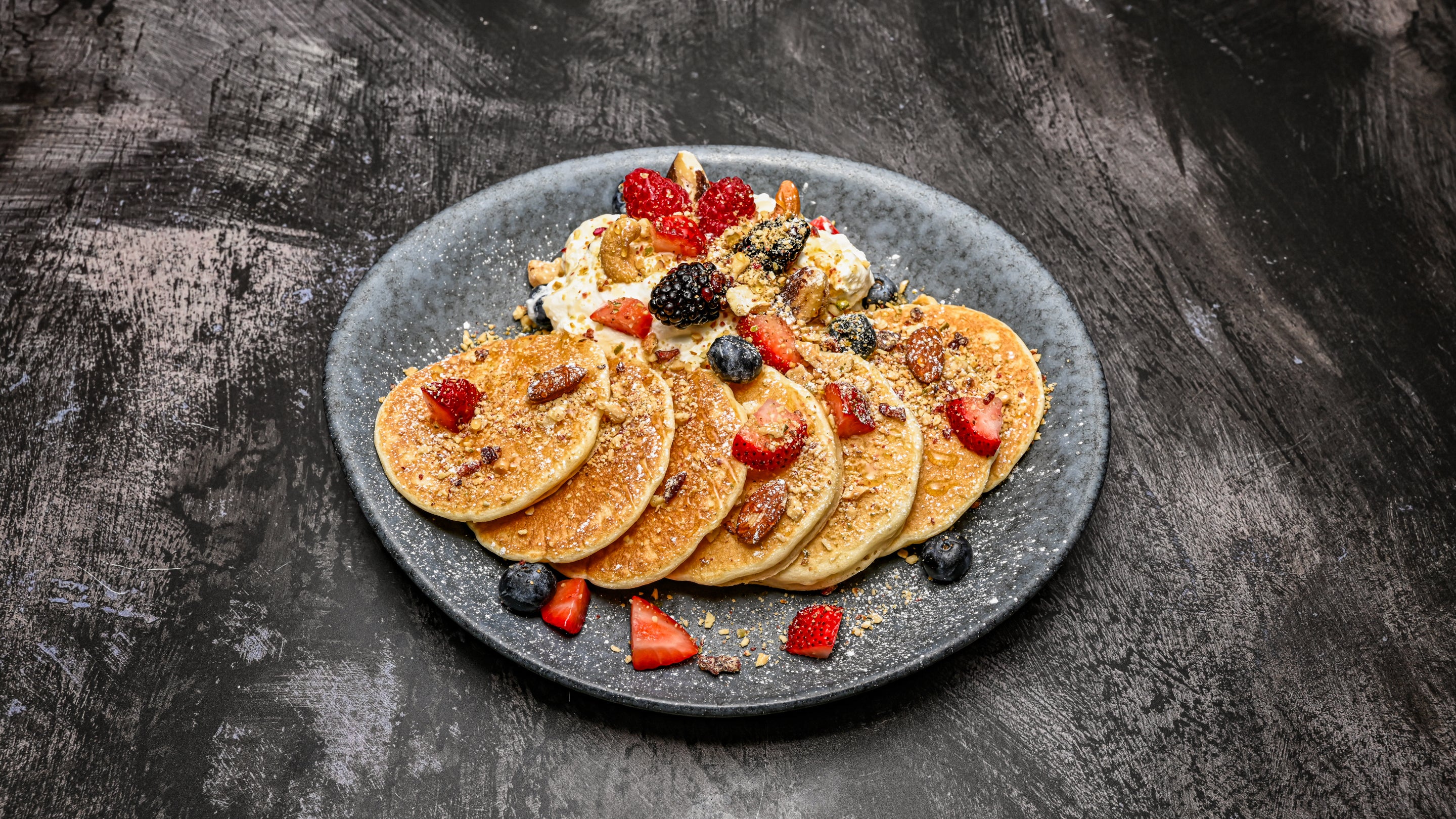 American pancakes with Greek yoghurt, berries, nuts, seeds, honey