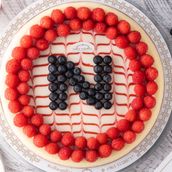 Cheesecake with berry letter