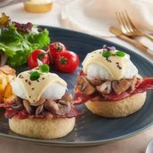 Oeufs benedicte with beef bacon and sauteed mushrooms