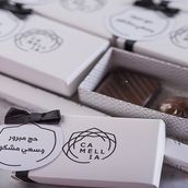 A Cardboard Distribution Tray Of 25 Boxes, Each Box Containing Two Chocolates, Along With Cards For Hajj Mabroor And Saay Mashkor