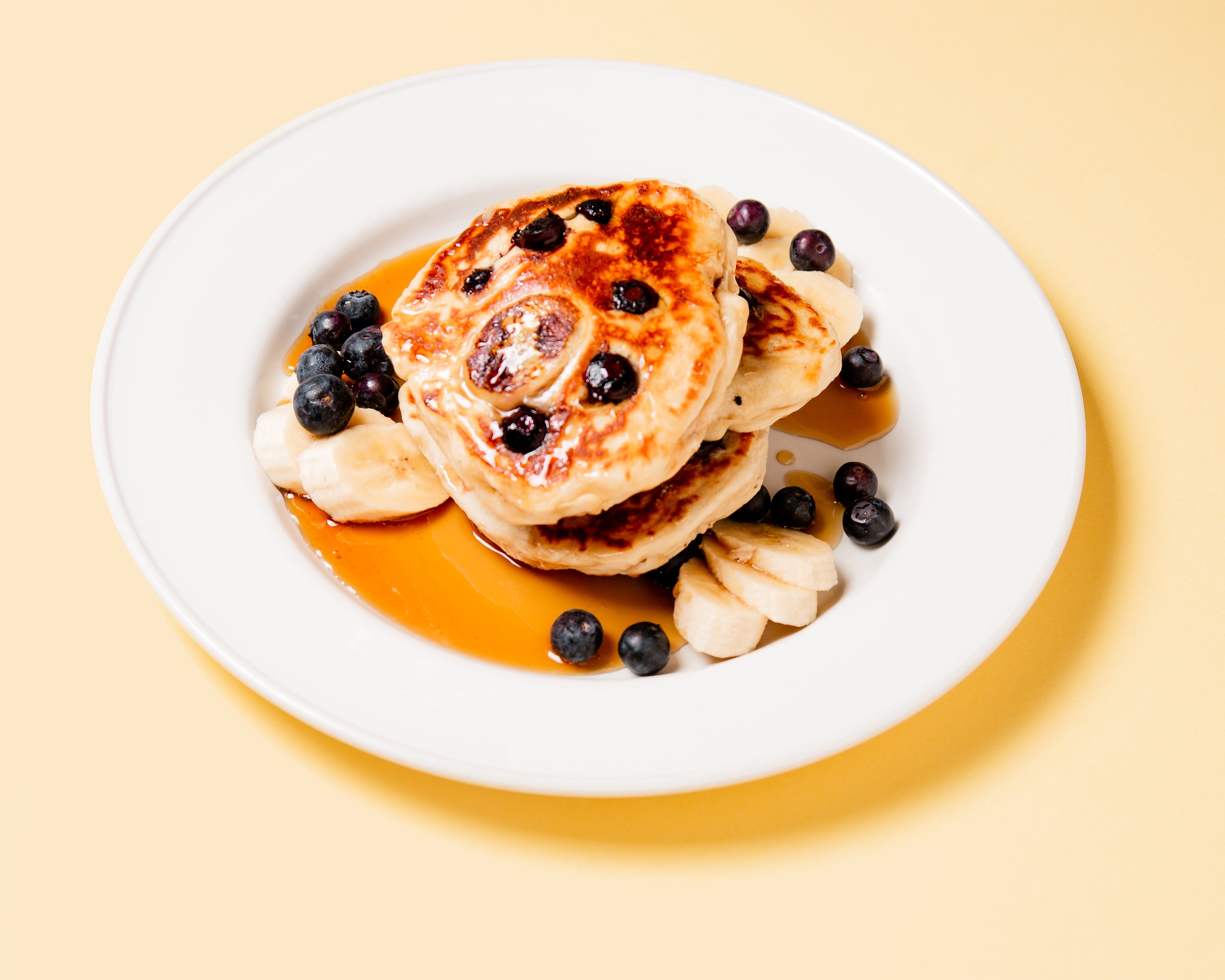 Vegan Pancakes with Vegan Sausages and Maple Syrup