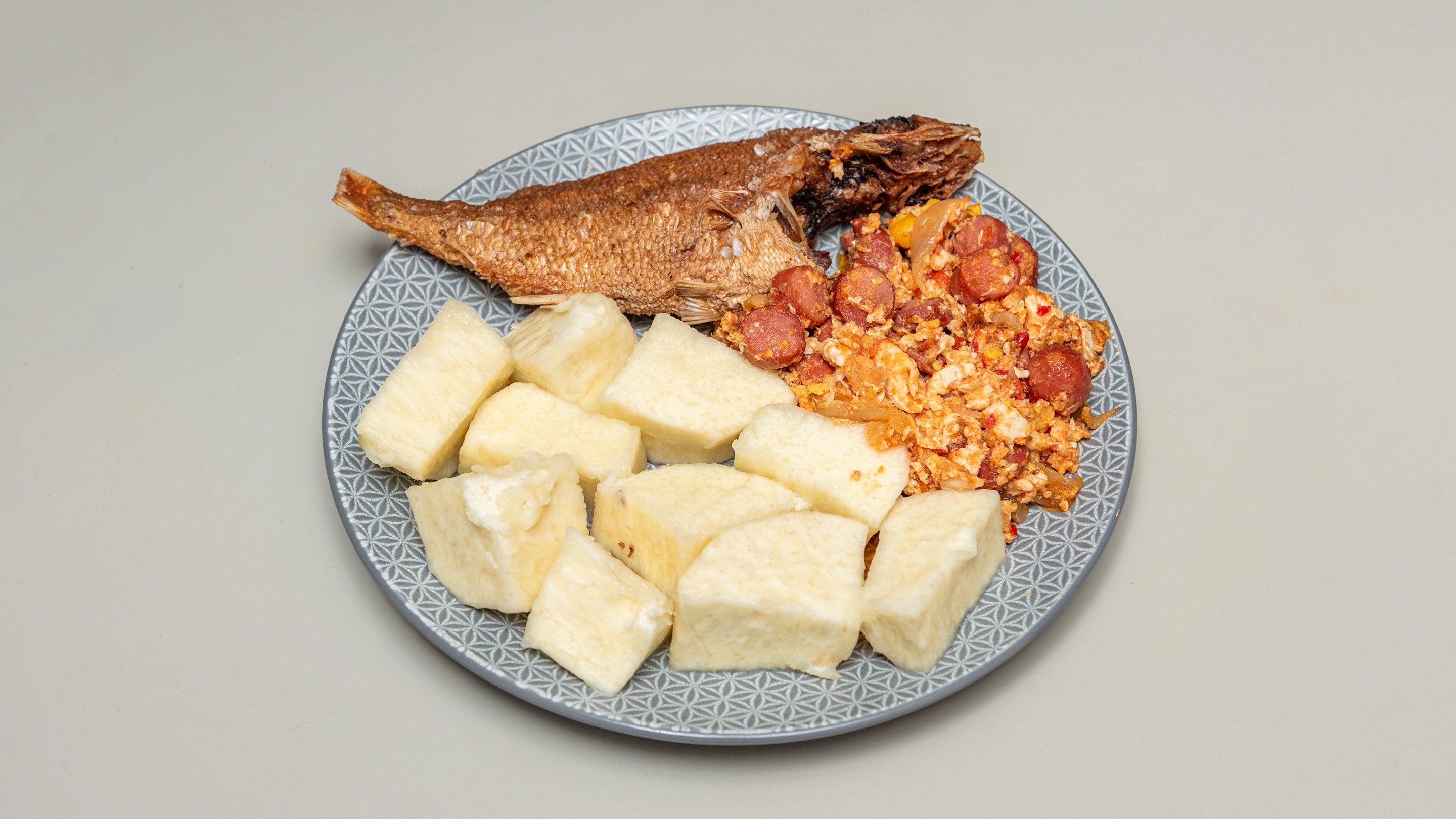 Boiled Yam with egg and sausages stew