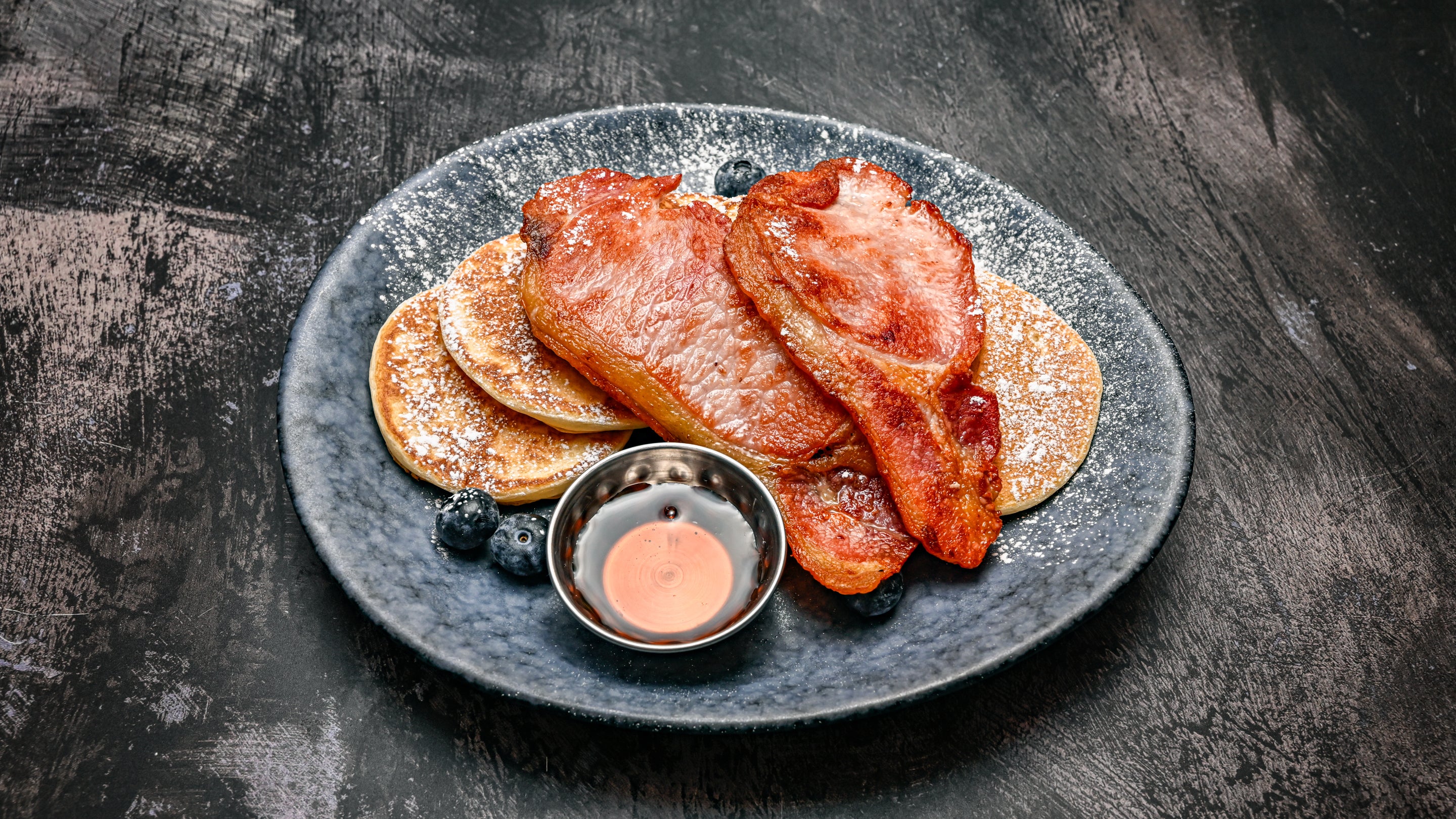 American pancakes with bacon, blueberries, maple syrup
