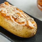 Baked Potato with Baked beans and spicy sauce with cheese