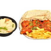 A whole grilled chicken with hummus, potatoes and bread with an oriental taste and irresistible spices
