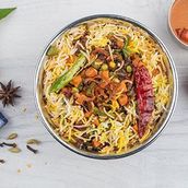 Veg Hydrabadi Biryani Served With Raita And Salad. 
