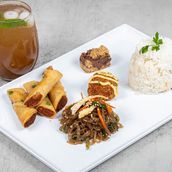 Spring Rolls, Korean Japchae Noodles, Plain Rice, Chicken Cheese Balls, Revel Bar Dessert, Iced Tea.
