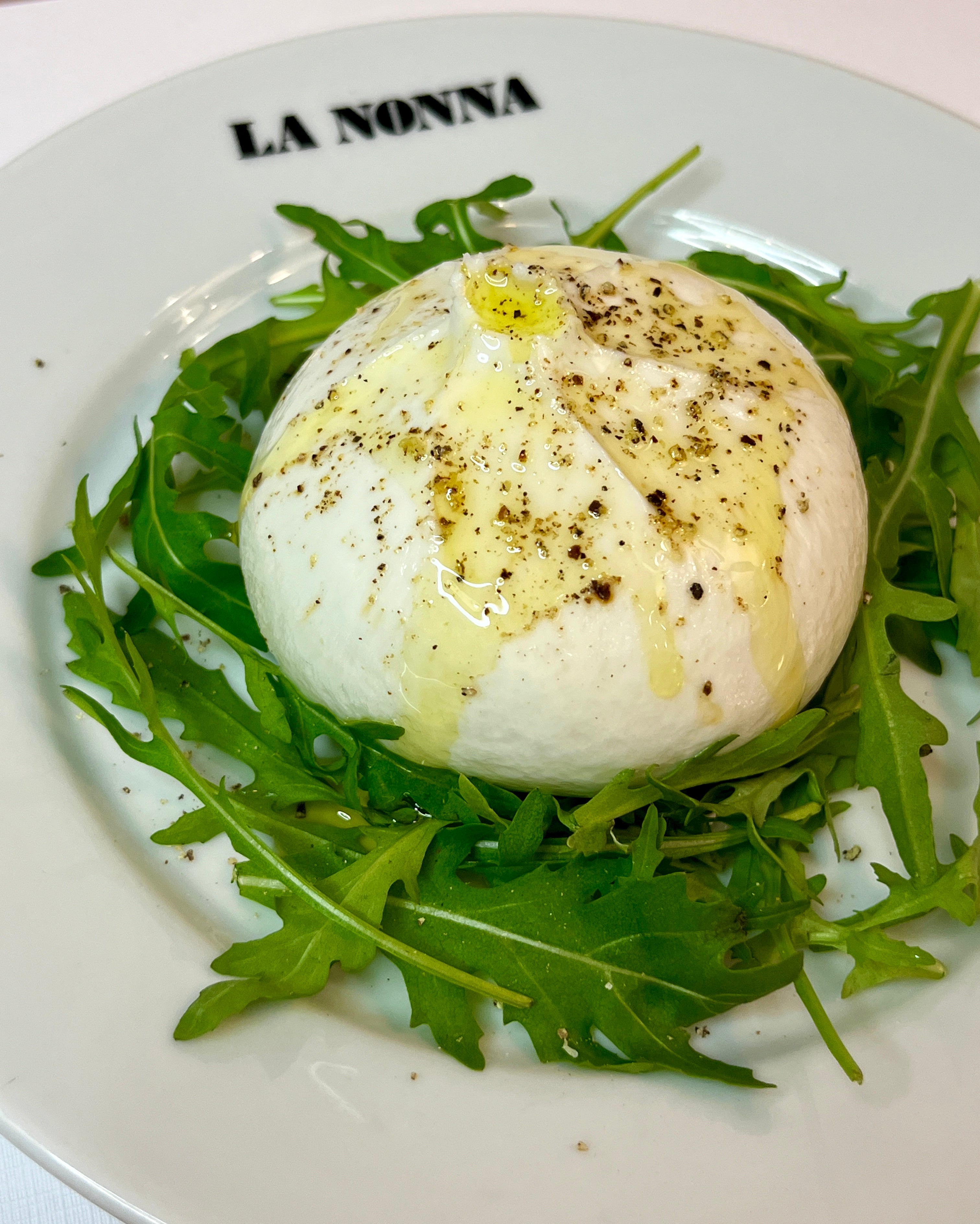 Burrata cheese with rocket, extra virgin olive oil & salt