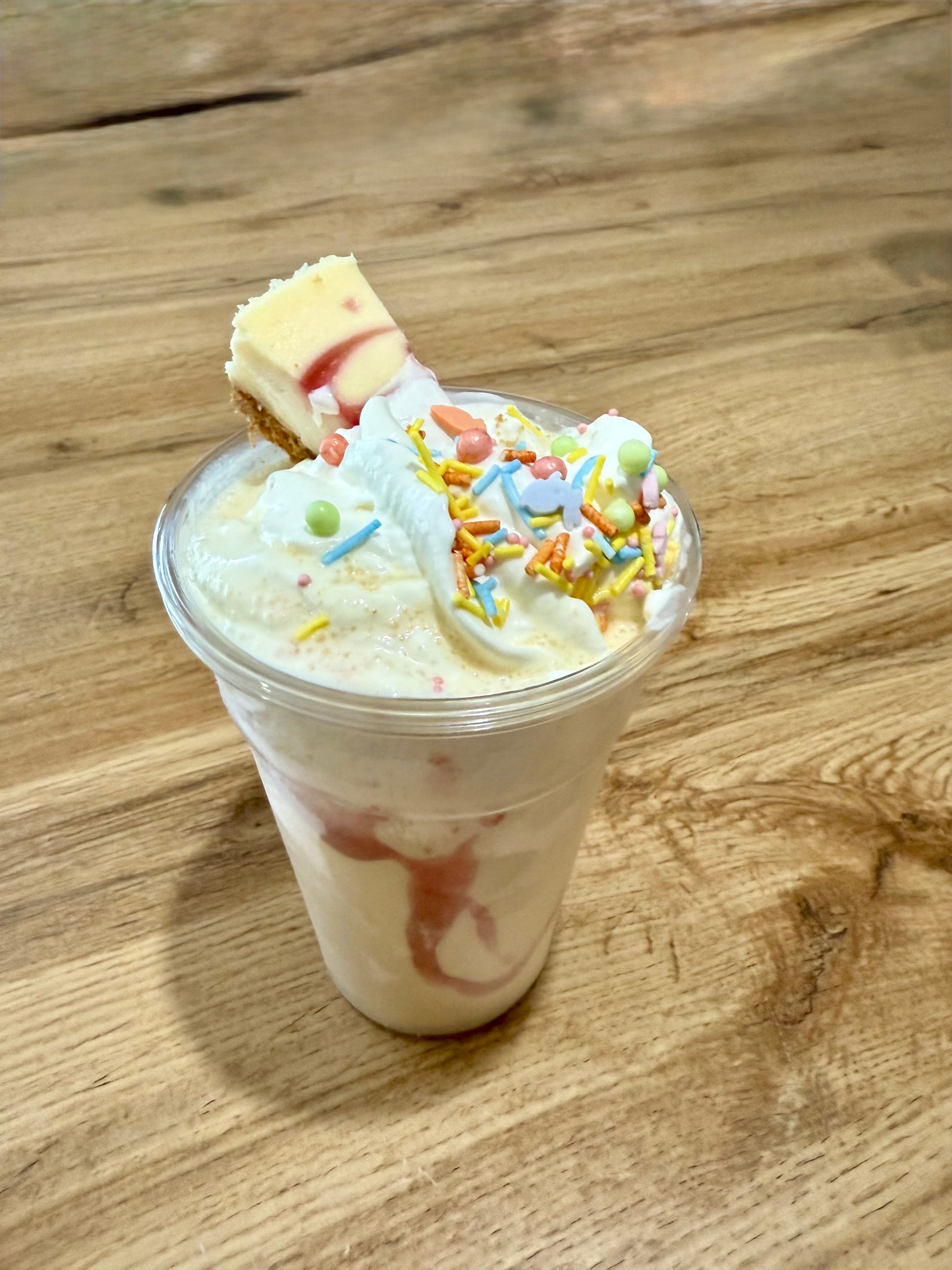 Cheesecake shake with cream and sprinkles