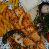 Enjoy Shish Taouk With Grilled Veggies salad and French fries.