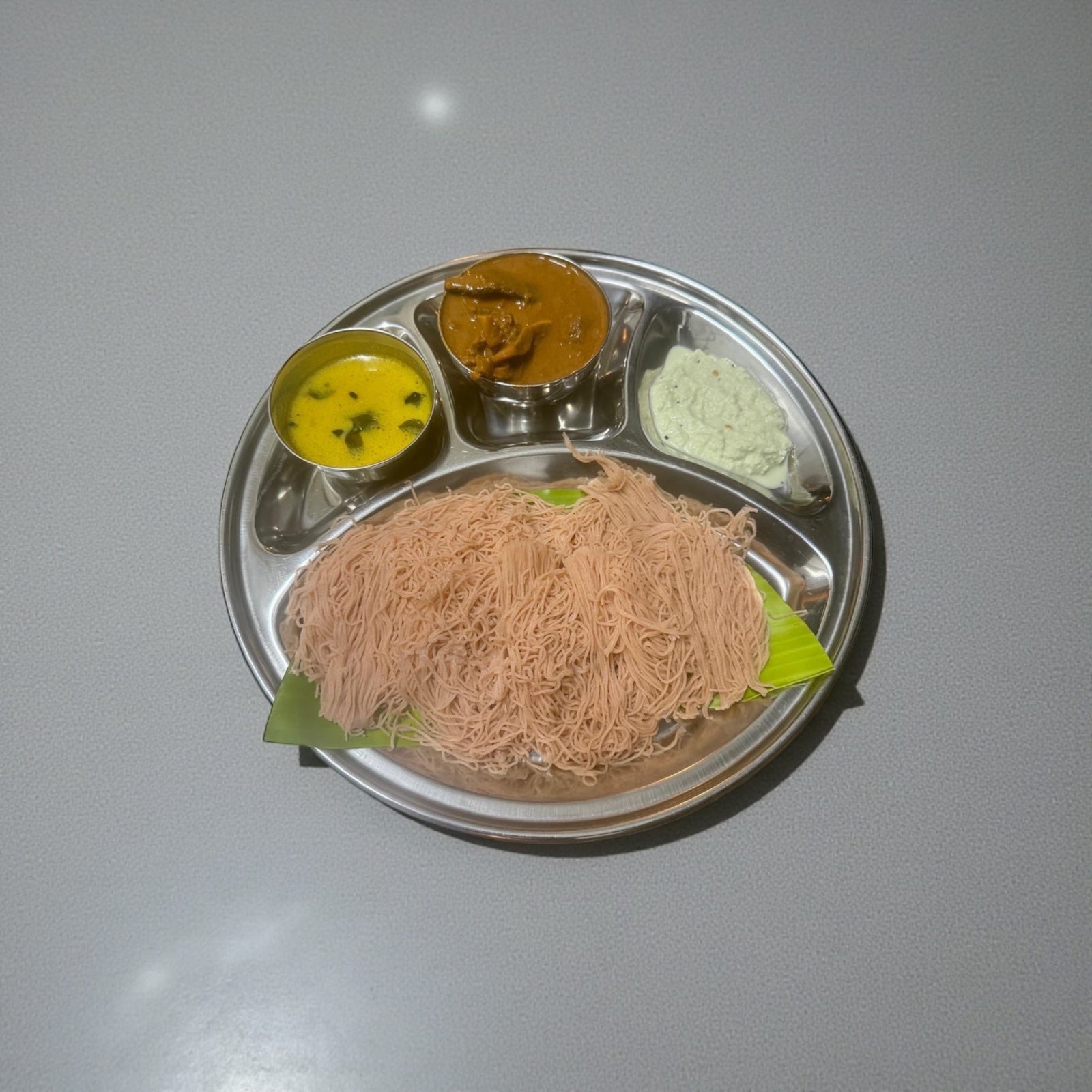 Idiyappam( String hoppers) come with mutton curry. dhal and chutney