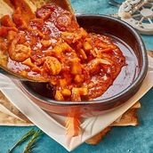 Shrimp dish with potatoes red sauce 