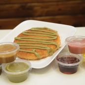 Kunafa stuffed with cream topped with pistachio sauce
