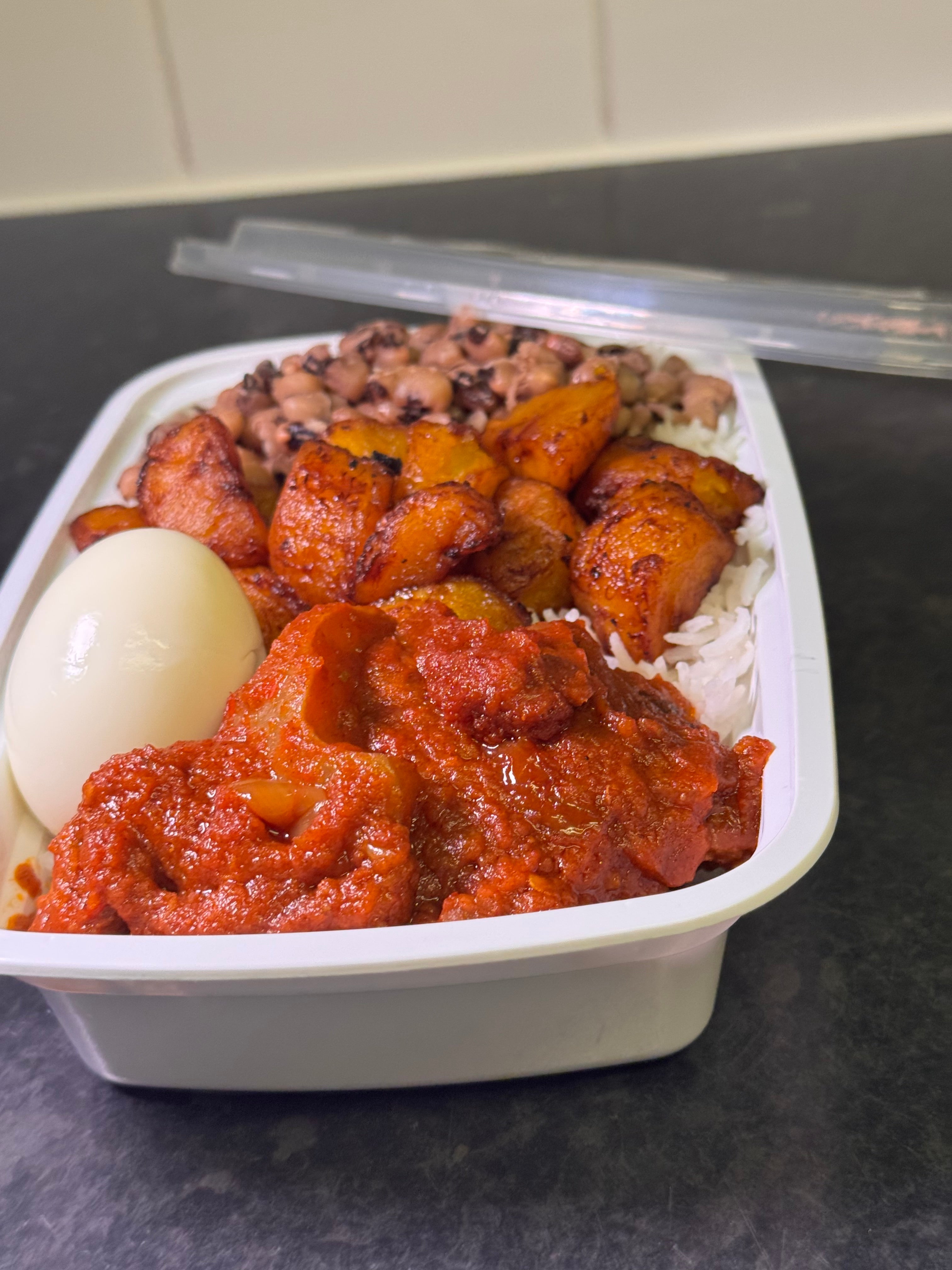 Basmati Rice with Assorted Meat Stew, Boiled Egg, Beans & Fried Plantain( Moderately Spicy )