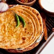 1 Gobhi Paratha Served With Curd And Green Chili.