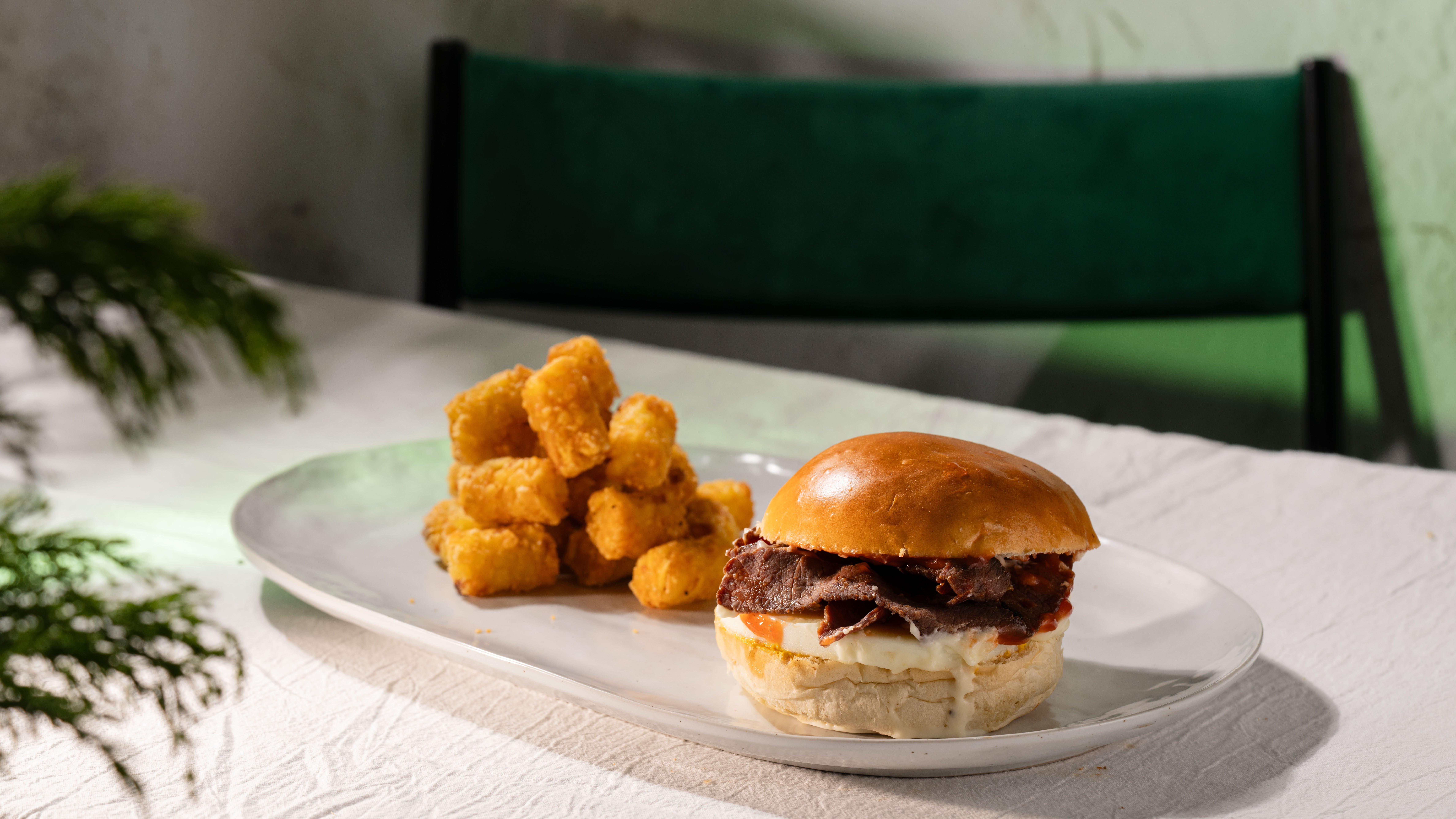 Beefy Egg, Bacon, and Sausage burger +Tots