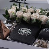 A White Tray Decorated With Natural White Roses Containing A Bag Of Chocolate, Incense, A censer And An Incense Stick