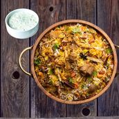 Mutton Biryani Juicy Slow Cooked Mutton With Fragrant Rice, Raita and Salad Must Try