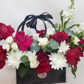 Red And White Mix Flowers Arrangement With The Black Bag