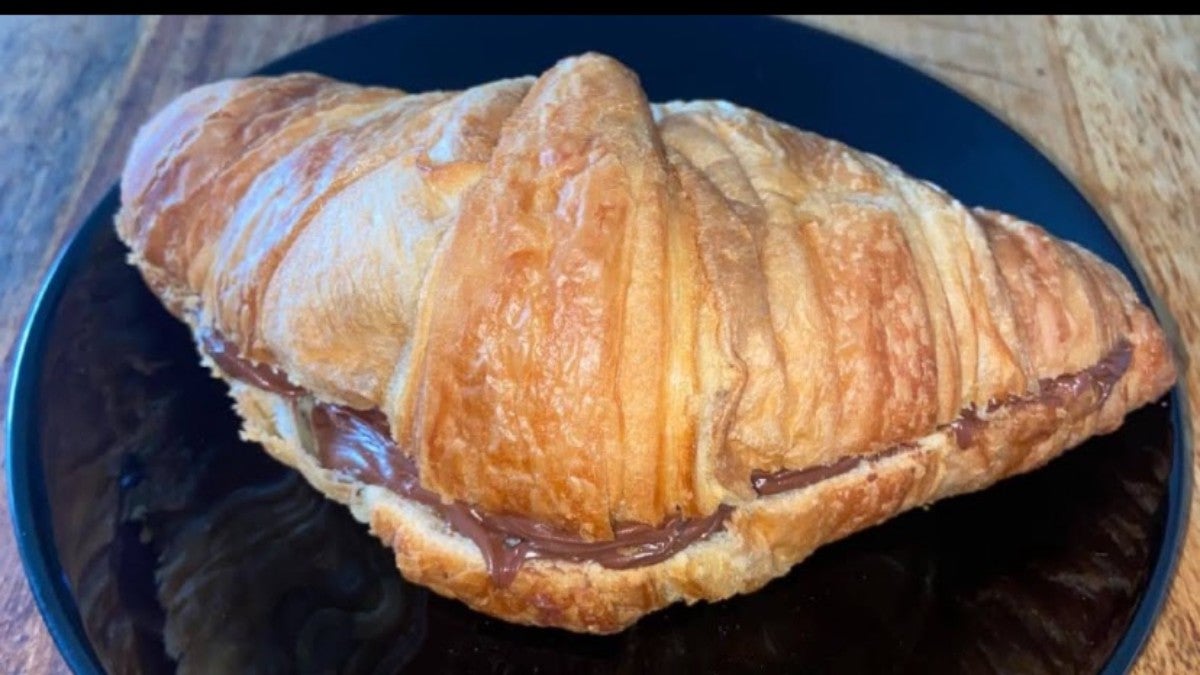 Hot croissant with chocolate hazelnut spread filling