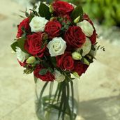 Red And White Flowers Arrangement Round Glass