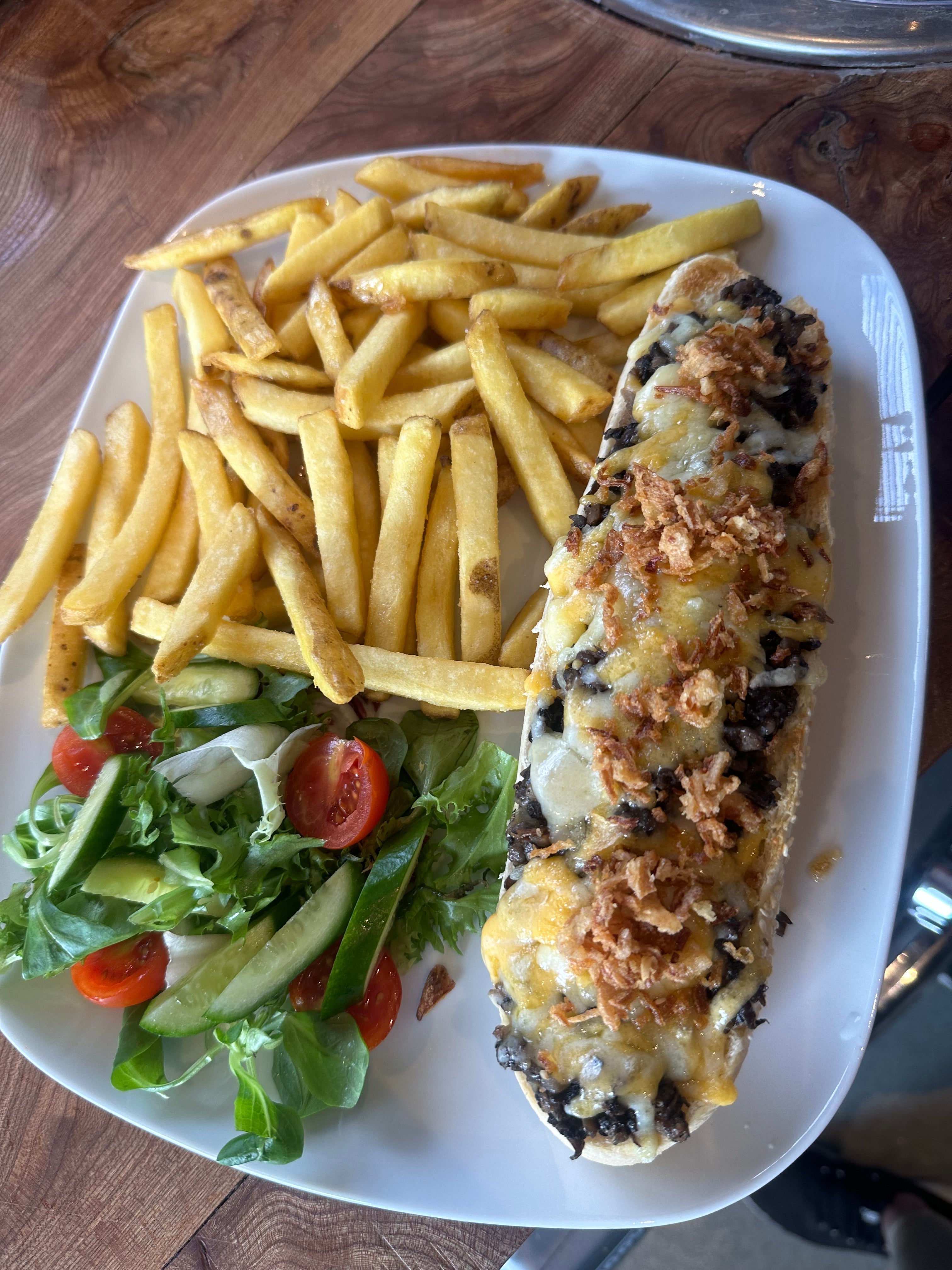 Baguette with ham and cheese served with fries